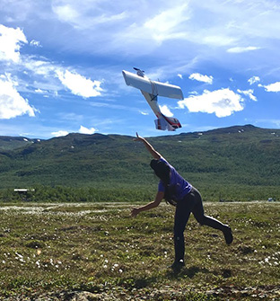 Jessica DelGreco (MS, 2018) launches a drone over arctic vegetation in Sweden.